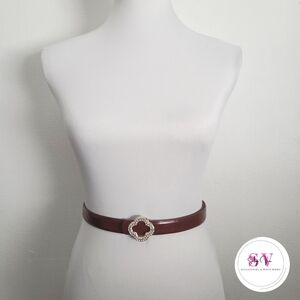 Burgundy belt with a rhinestone clover buckle